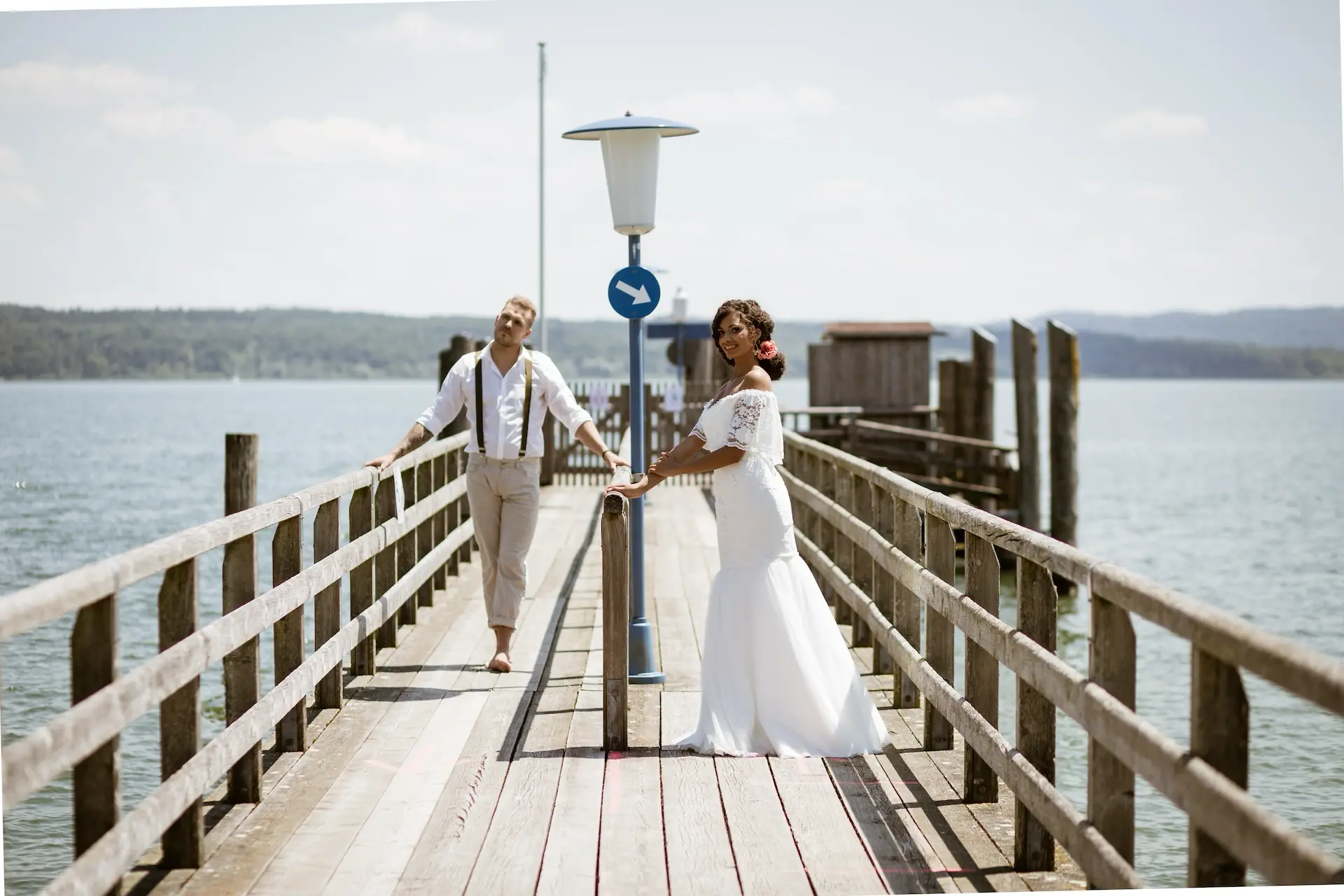 traumhochzeit braut und braeutigam auf steg am wasser